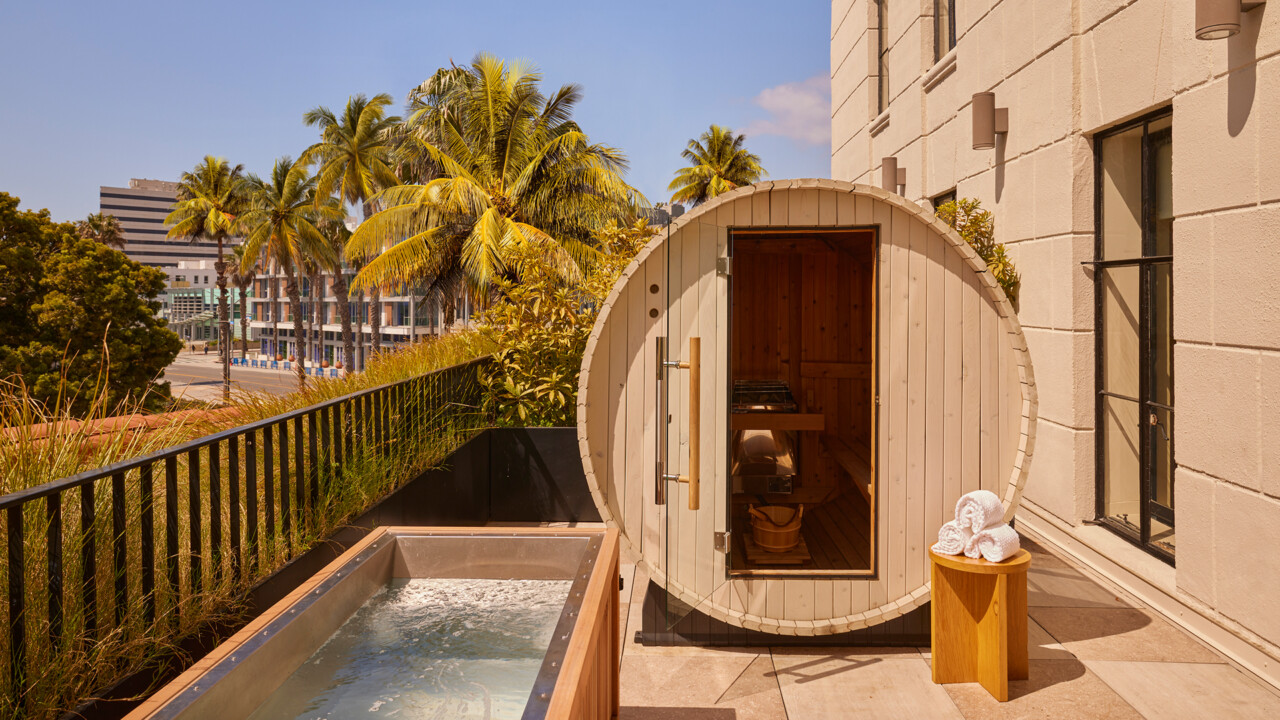 Rooftop barrel sauna and cold plunge overlooking palm trees at Santa Monica Proper