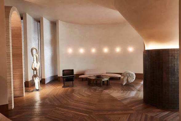 Curved lounge alcove at Santa Monica Proper with sculptural lighting and herringbone floors